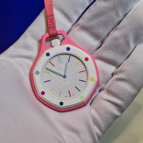 Royal Pop pink octagonal pocket watch with white bezel, multicolor hex screws and tapisserie dial on pink leather lanyard